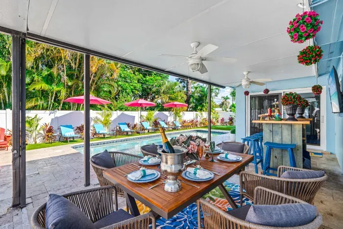 Relax under the covered pergola with a bar and dining area, ideal for outdoor meals and entertaining.