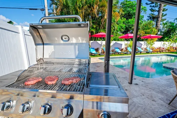 Host a BBQ or outdoor game night in the fully fenced backyard, perfect for family fun and gatherings.