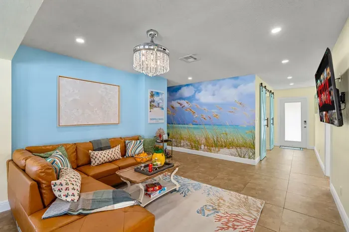 Unwind in comfort with the cozy sofa, stylish coffee table, and a unique wallpaper bringing the outdoor beauty into the heart of the living room.