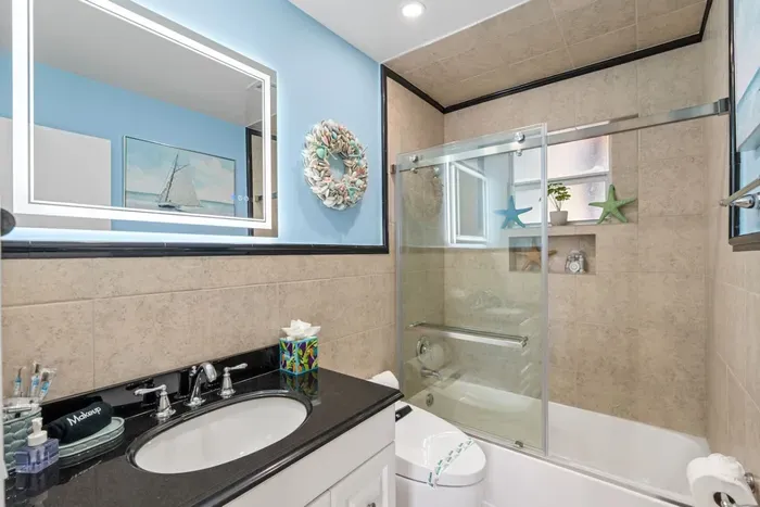 Refresh in a modern bathroom with a bathtub and shower, perfect for unwinding after a day of adventure.