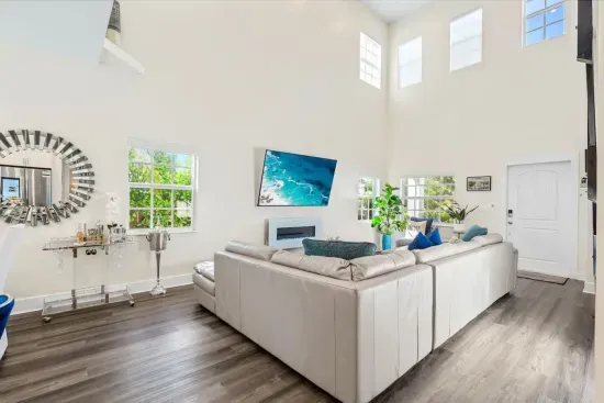 The super high ceilings within the family room really gives a spacious and airy feel whilst the electric fireplace gives off an ambient and cozy affect when chilling out on the huge sofa.