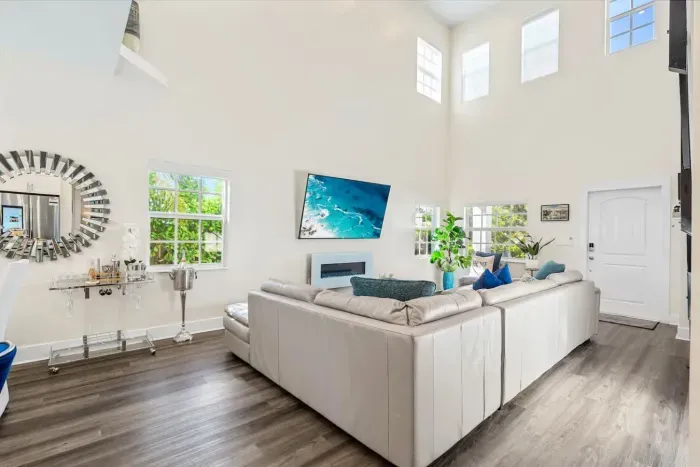 The super high ceilings within the family room really gives a spacious and airy feel whilst the electric fireplace gives off an ambient and cozy affect when chilling out on the huge sofa.