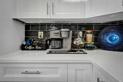 Who is ready for their cup of coffee in this beautiful kitchen?  How about taking it outside to the outdoor dining table or perhaps relaxing on the sun lounger.