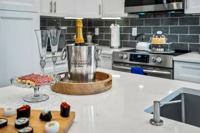 Have a few drinks at the kitchen bar while watching the designated chef in action.