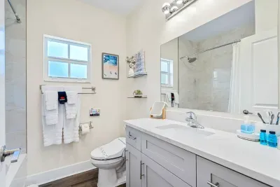 Make your way into the full bathroom found upstairs, with another beautiful, modern interior, a large vanity area and a fully tiled shower bath combo.
