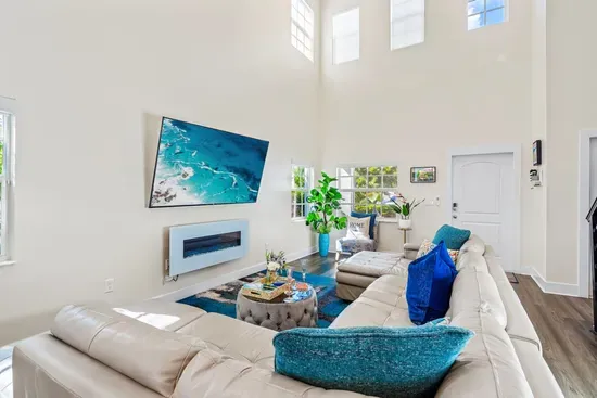 The super high ceilings within the family room really gives a spacious and airy feel whilst the electric fireplace gives off an ambient and cozy affect when chilling out on the huge sofa.