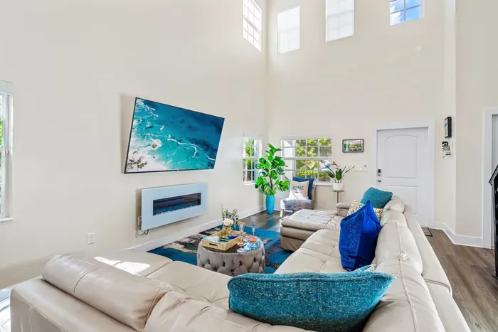 The super high ceilings within the family room really gives a spacious and airy feel whilst the electric fireplace gives off an ambient and cozy affect when chilling out on the huge sofa.