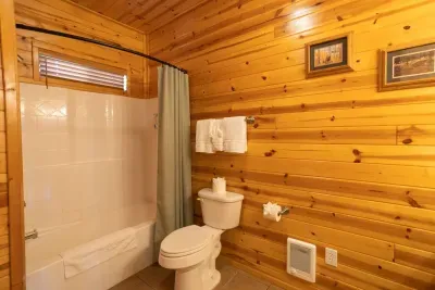 The spacious bathroom has a large vanity and a tub/shower combo.