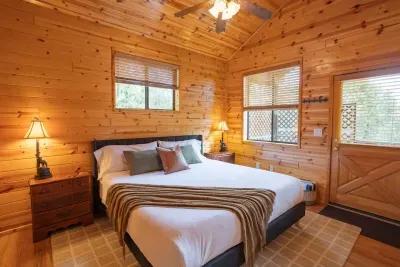 King-size bed with purple mattress. Door to private deck with hot tub. 