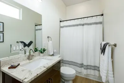 The third bathroom is across the hall from the bunk room. It features a tub/shower combo. 