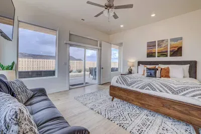The second bedroom features a king-sized bed, a futon sleeper couch, smartTV, an ensuite bathroom, and a separate entrance to the back porch. 