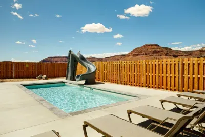 Your own private pool and slide with the best red rock views around! We even keep it heated at no extra cost!