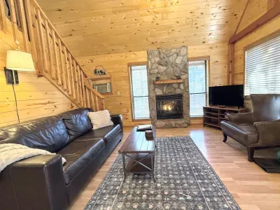 The living room perfect place to lounge with a good book after a day of exploring. The cozy fireplace is perfect for the winter and the AC unit keeps the cabin cool in the summer. Roku TV for streaming.