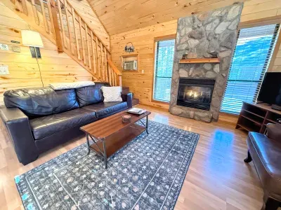 Comfortable leather sleeper sofa can fold out and sleep 2 people. TV has streaming available for you to log into your favorite services. The propane fireplace keeps it nice and cozy.