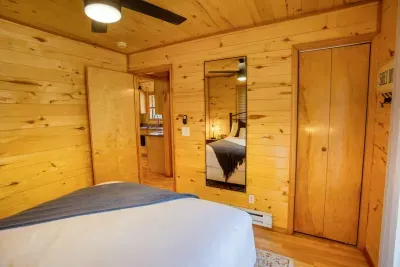 The bedroom has a full-length mirror, closet, ceiling fan, and heater.