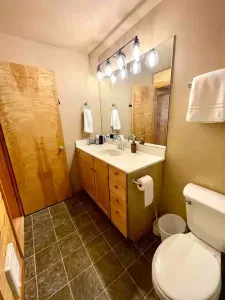 The bathroom has a shower/tub combo and a large vanity with plenty of counterspace. 