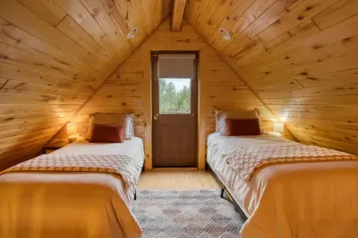 The loft has two twin beds and the door to the upper level star-gazing deck. 