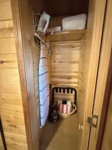 Guest-ready closet with iron, board, hangers, towels & luggage rack