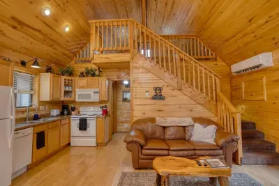 The living room has comfortable leather furniture. The couch pulls out to a full-size bed and the new mini-split keeps the temperature comfortable.