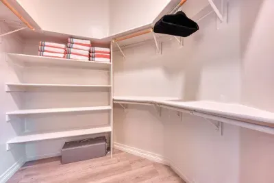 Primary walk-in closet is stocked with pool towels and a pack n play for our smaller guests. 