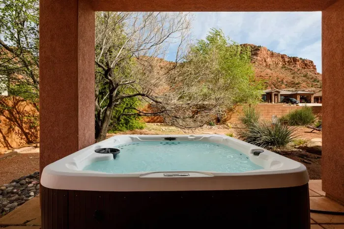 Brand new private hot tub on the back patio just outside the doors from the primary suite. Relax and take in the views of the red cliffs and the stars!