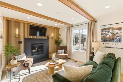 Cozy living room with fireplace, smartTV, and queen-sized sleeper sofa.