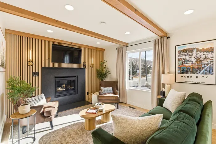 Cozy living room with fireplace, smartTV, and queen-sized sleeper sofa.