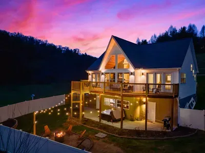 Stunning fire pit area (adorned with string lights) to relax and make smores with the family.