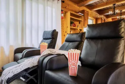 Kick back, relax and watch movies in the theatre room with 6 reclining chairs & popcorn machine