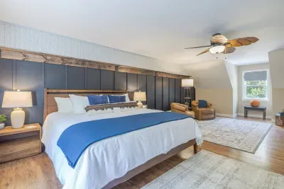 Quiet Master bedroom with king bed, luxury linens, smart tv, private seating and walk in closet.  This room is large enough to comfortable fit a crib, pack and play or an moveable bed for a little one.