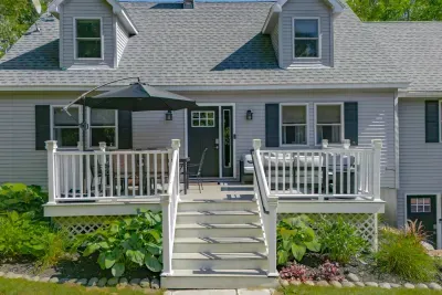 The deck comes with an expandable patio table and umbrella to keep you cool on hotter days.  There is also a comfortable sofa, love seat and single seats available to gather around the gas firepit.