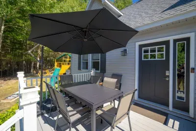 The outdoor dining table is expandable and can comfortably seat eight.  Additional seating can be found just to the right next to the gas firepit.