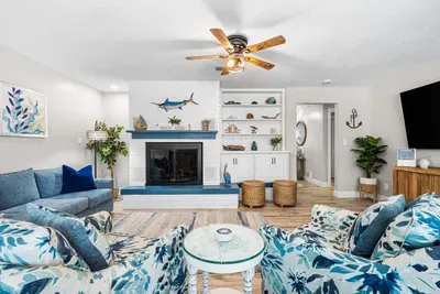 Coastal-chic living room with fireplace, built-ins, and inviting seating