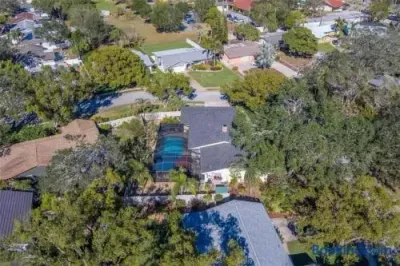 Private tree-lined home with screened pool in a peaceful neighborhood