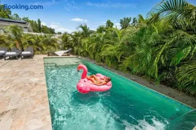 Private tropical pool with sun loungers and a lush resort-style setting
