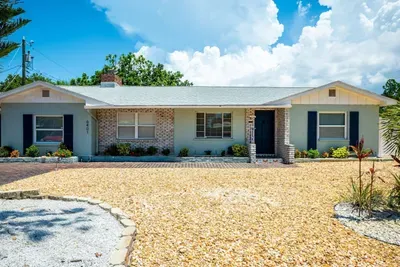 Exterior of Tropical Disco — 4-bedroom private pool vacation rental, Gulfport/South St. Petersburg, FL. Driveway parks up to 6 vehicles.