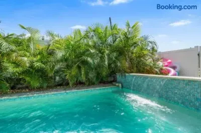 Private tropical pool with waterfall feature and lush resort-style vibe