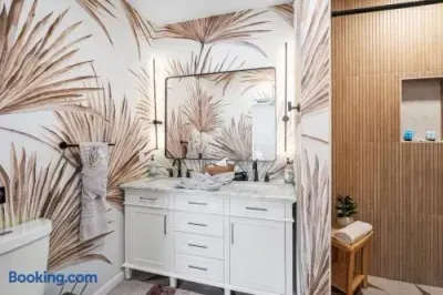 Spa-inspired bathroom with double vanity and striking tropical wallpaper