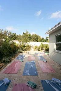 Backyard travertine pool deck — spacious enough for poolside yoga, entertaining, or just lounging. Private fenced yard, St. Petersburg, FL.