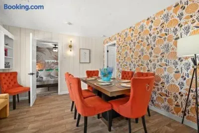 Bright dining room with bold coastal wallpaper and seating for six