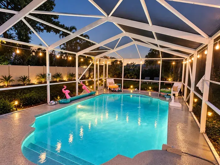 Private year-round pool with loungers, pool toys, and tropical surroundings, with heating included November through March.