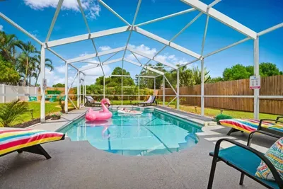 Private year-round pool with loungers, pool toys, and tropical surroundings, with heating included November through March.