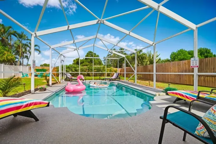 Private year-round pool with loungers, pool toys, and tropical surroundings, with heating included November through March.