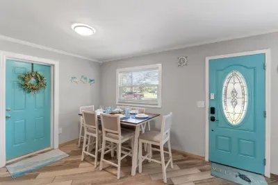 A bright and cheerful dining space with a touch of coastal charm. Gather, dine, and make yourself at home.
