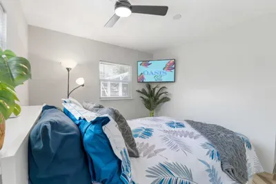 Bright queen bedroom with coastal luxury bedding