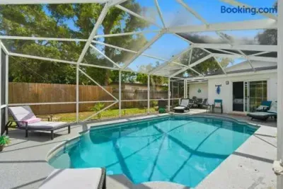 Private screened pool with lounge chairs and easy indoor-outdoor access