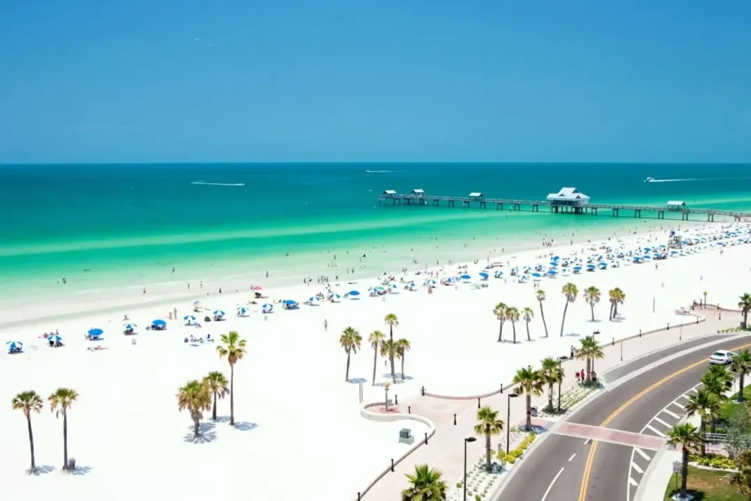 Aerial view of a white-sand Gulf beach and fishing pier