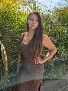 Devon, lead concierge at Kermay Escapes, standing among tropical palms