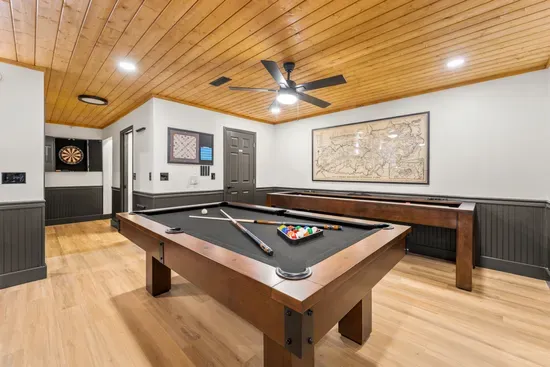 Stylish game room with pool, shuffleboard, and dartboard fun