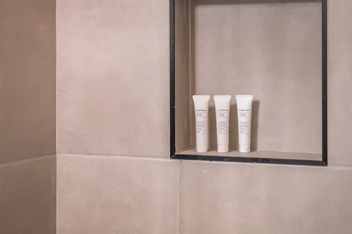 Modern tiled shower niche with upscale toiletries and spa-like style